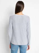 Light gray, V-neck, long-sleeved cashmere blend sweater.  Ribbed texture,  subtle openwork detail at shoulders.