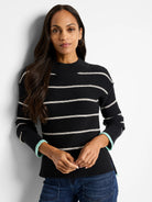Black waffle-knit sweater with thin off-white stripes and mint green cuffs.