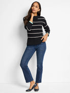 Black waffle-knit sweater with thin, horizontal off-white stripes and teal cuffs.