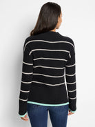 Black waffle-knit sweater with thin off-white stripes and teal cuffs.
