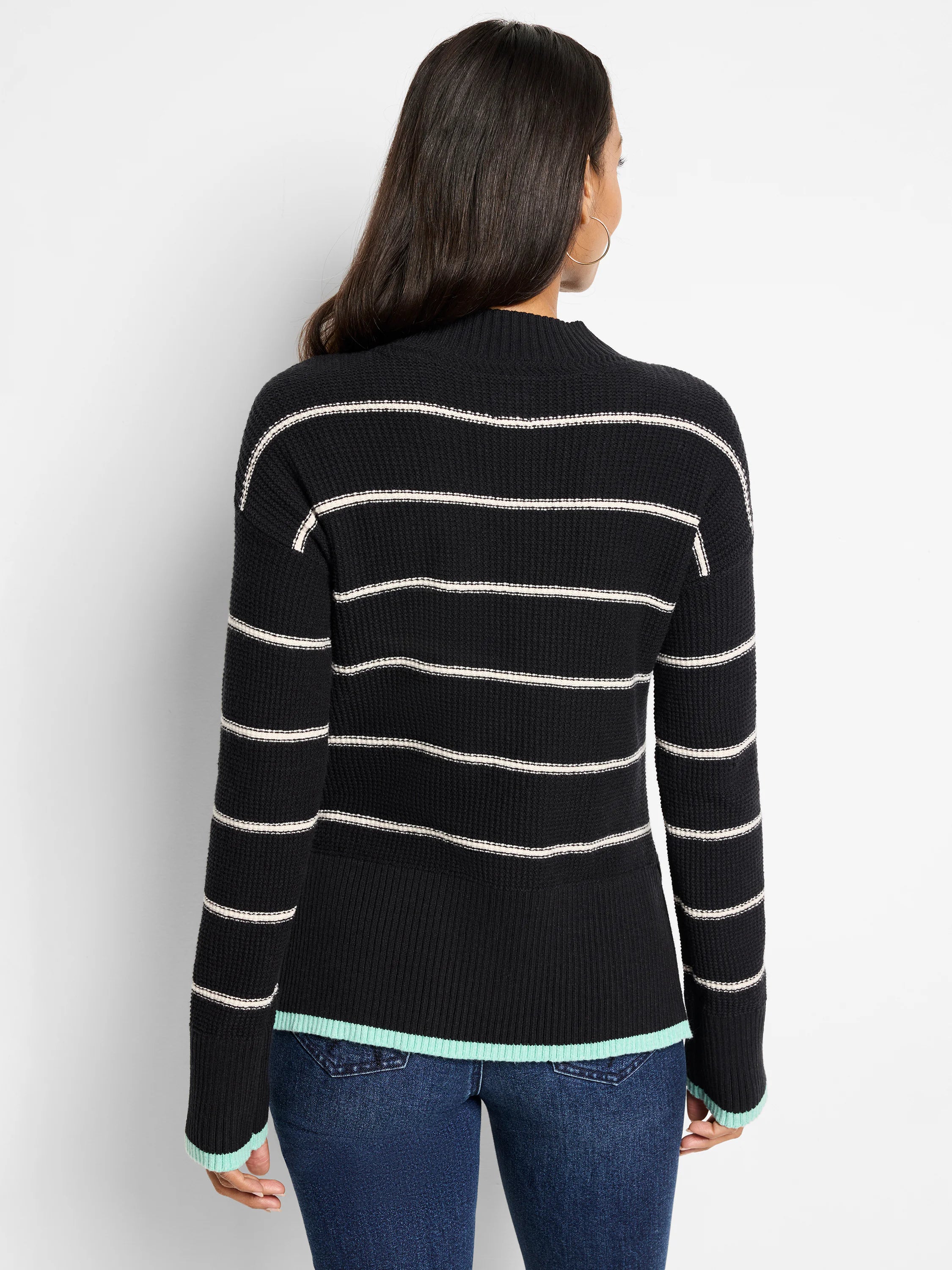 Black waffle-knit sweater with thin off-white stripes and teal cuffs.