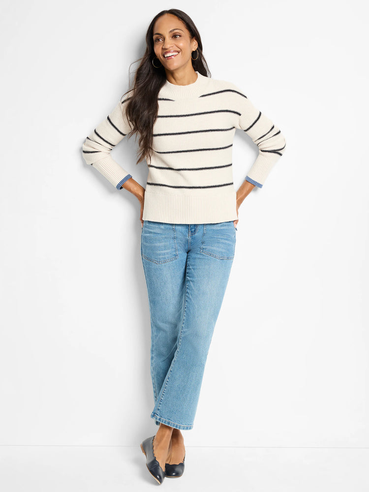 Cream waffle-knit sweater with thin dark stripes;  mock neck.