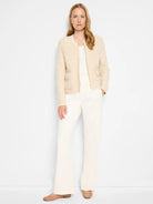 Off-white sherpa zip-up jacket with patch pockets, shown on a model.