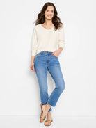 Off-white dolman-sleeve sweater on a model.  The sweater has a V-neck.