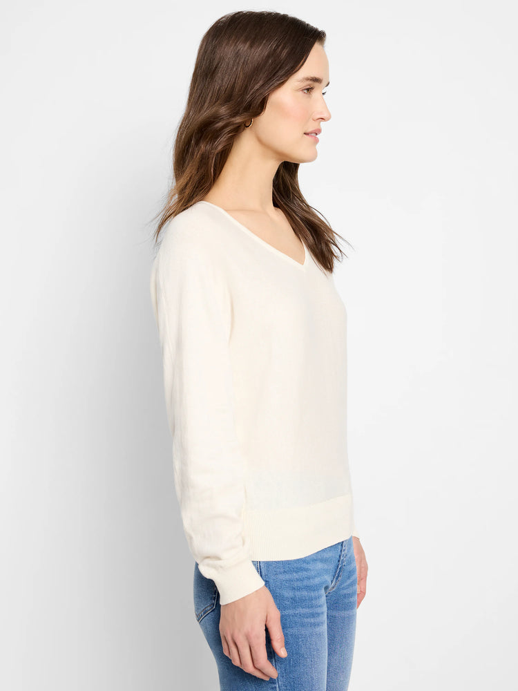 Off-white dolman-sleeve V-neck sweater.  Long sleeves, fitted at wrists.