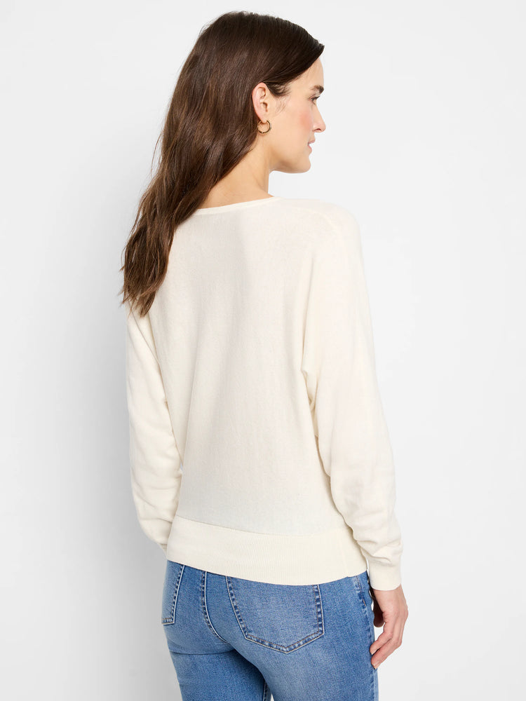 Off-white dolman-sleeve sweater, shown from the back.  The sweater has a ribbed bottom band.