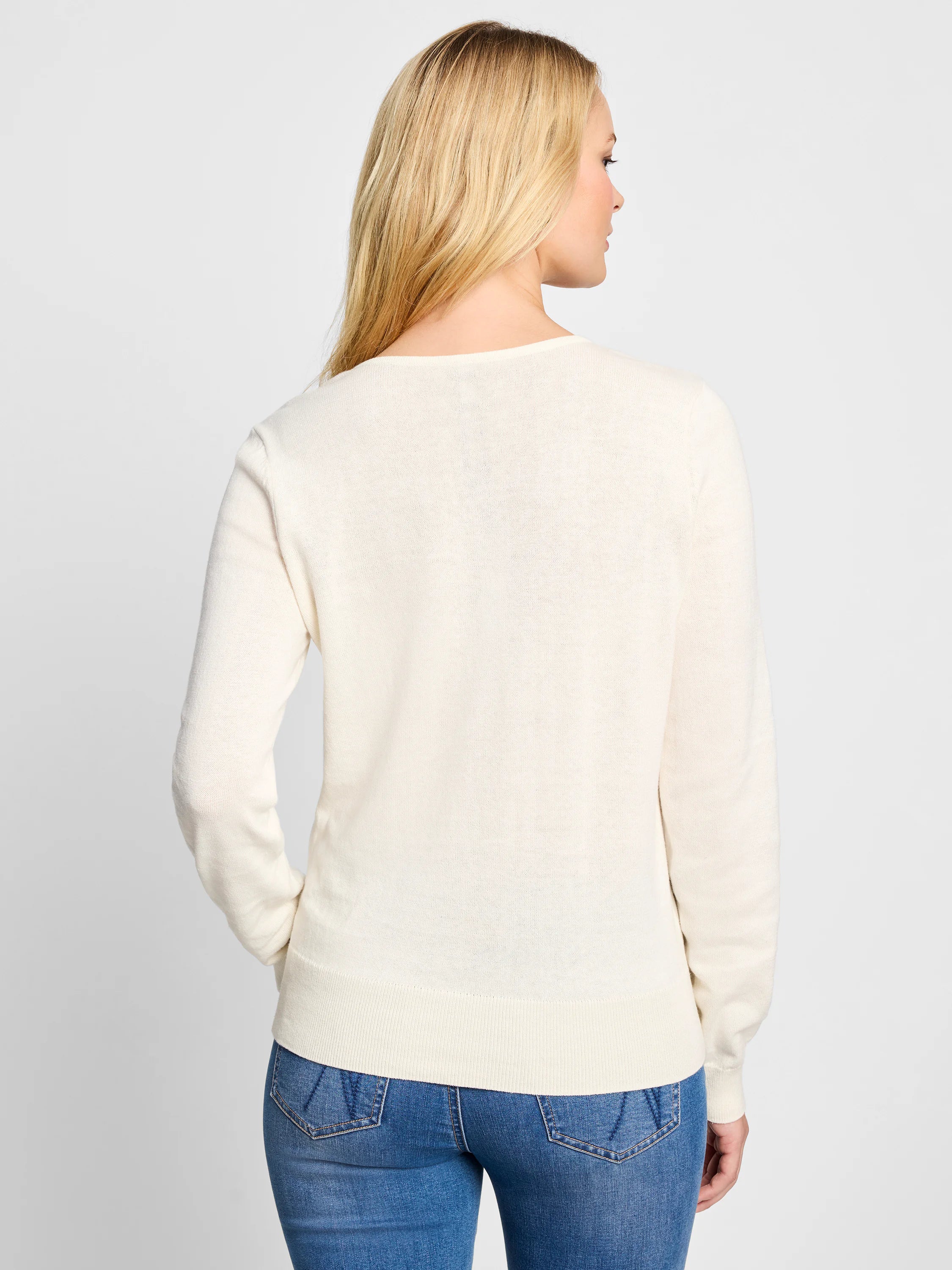Off-white, long-sleeved sweater;  shown from the back.