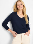 Navy blue, long-sleeved V-neck sweater.