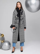 Black and white houndstooth reversible long jacket with black trim.  Features a self-tie belt.