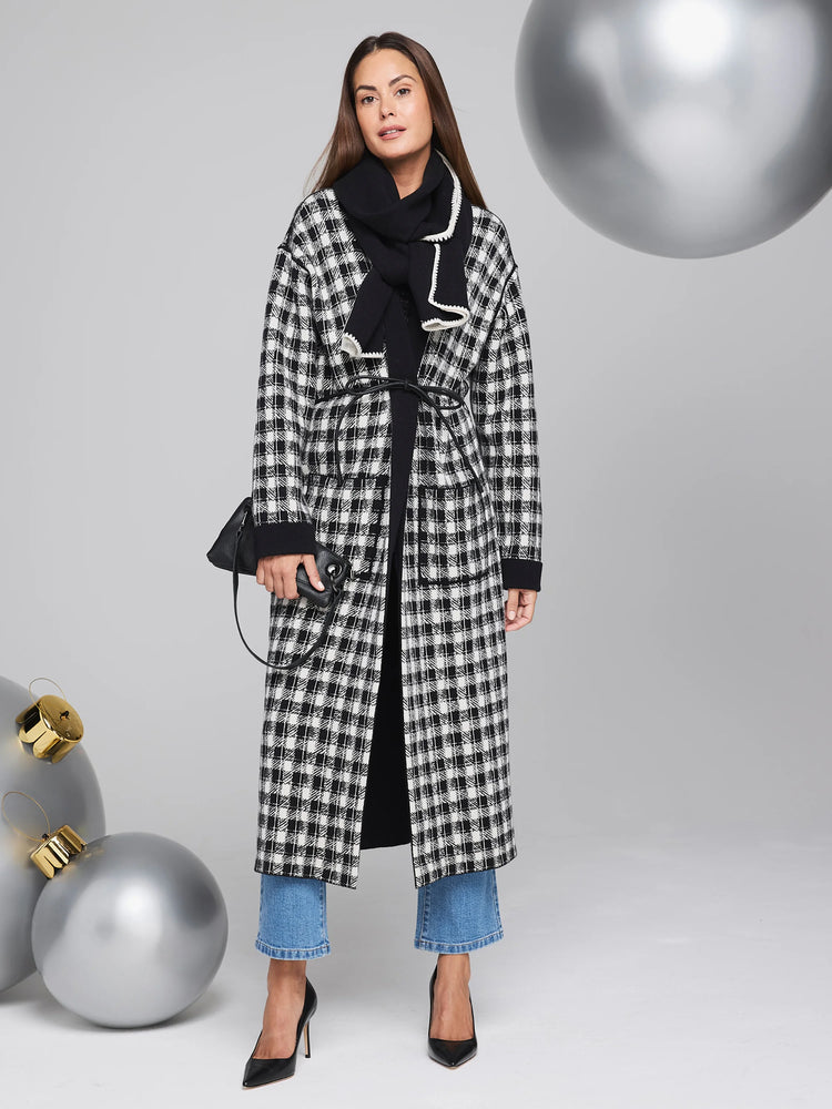Black and white houndstooth reversible long jacket with black trim.  Features a self-tie belt.
