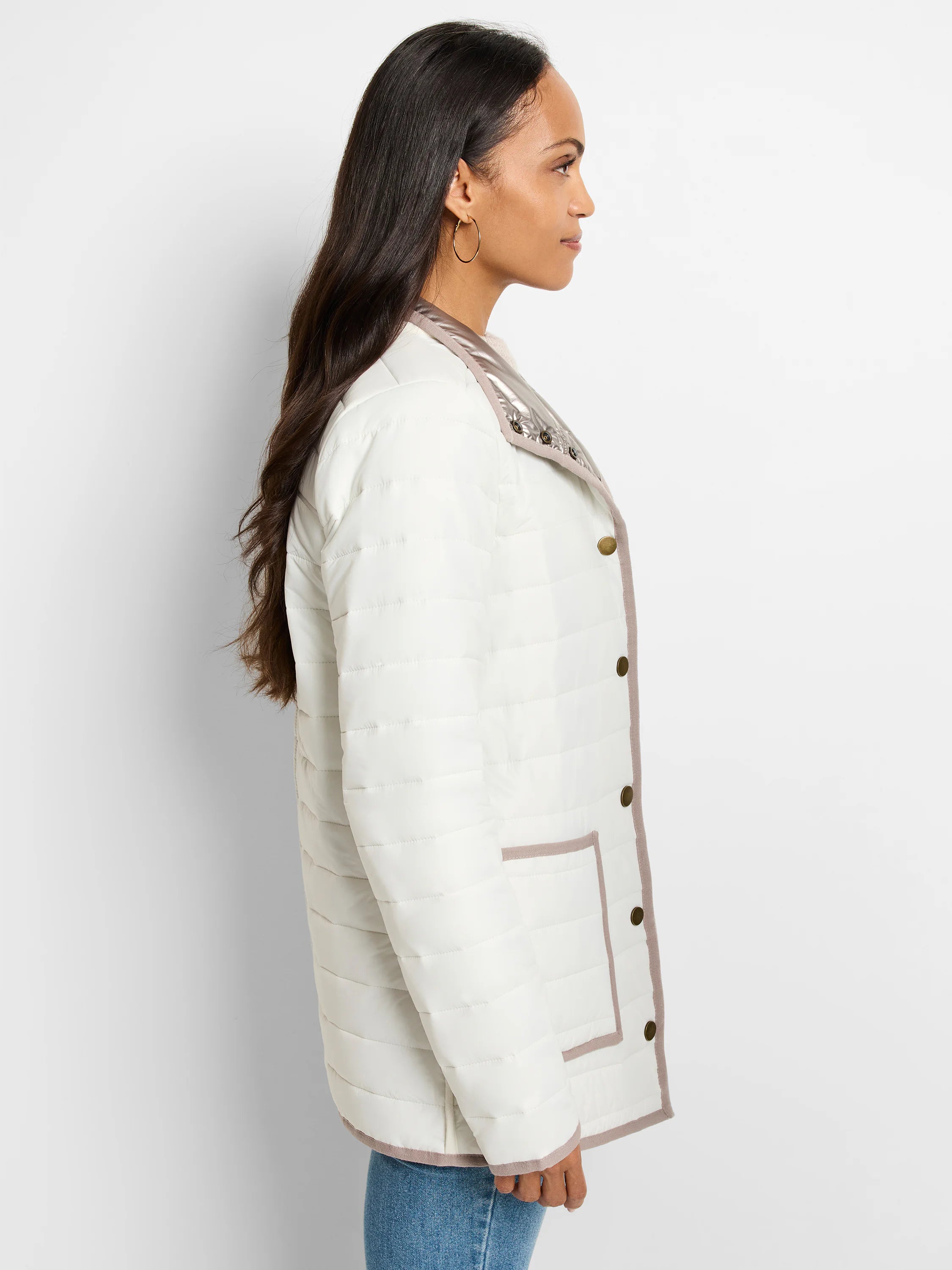 Off-white quilted puffer jacket with taupe trim & shiny metallic taupe reversible side. Features gold snap buttons.