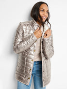 Shiny metallic bronze puffer jacket with horizontal quilting, light cream interior, and gold snaps.