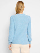 Sky blue waffle stitch sweater, back view. Ribbed neck and cuffs, subtle puff shoulders.