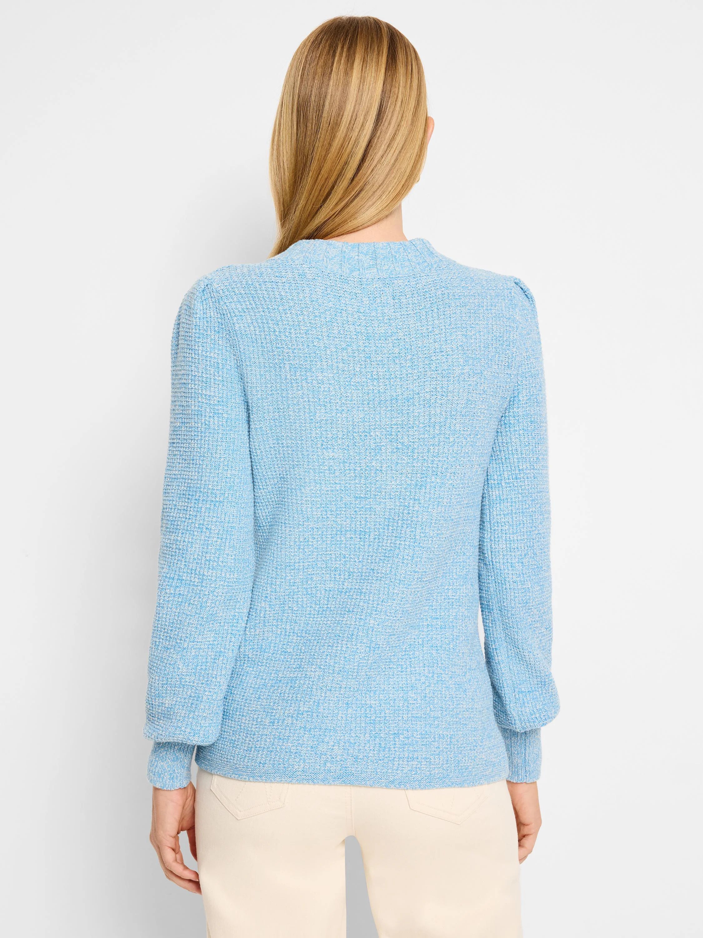 Sky blue waffle stitch sweater, back view. Ribbed neck and cuffs, subtle puff shoulders.