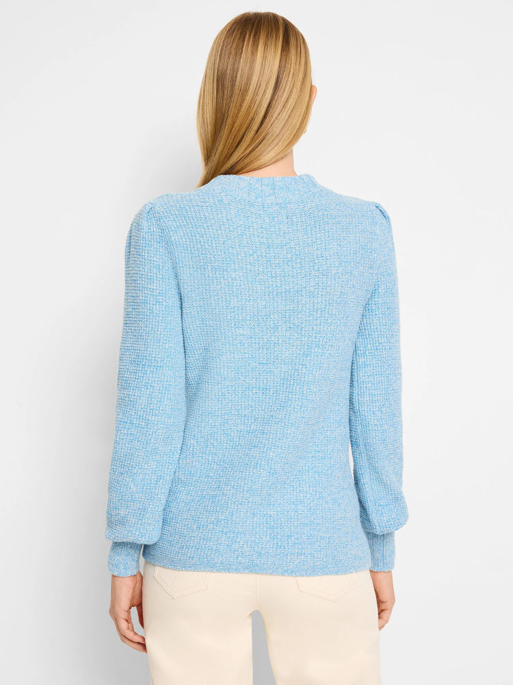 Sky blue waffle stitch sweater, back view. Ribbed neck and cuffs, subtle puff shoulders.