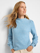 Light blue marled waffle stitch sweater with mock neck, long sleeves, and ribbed cuffs.