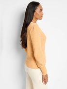 Marled orange waffle stitch sweater, crew neck, subtle puff shoulders.