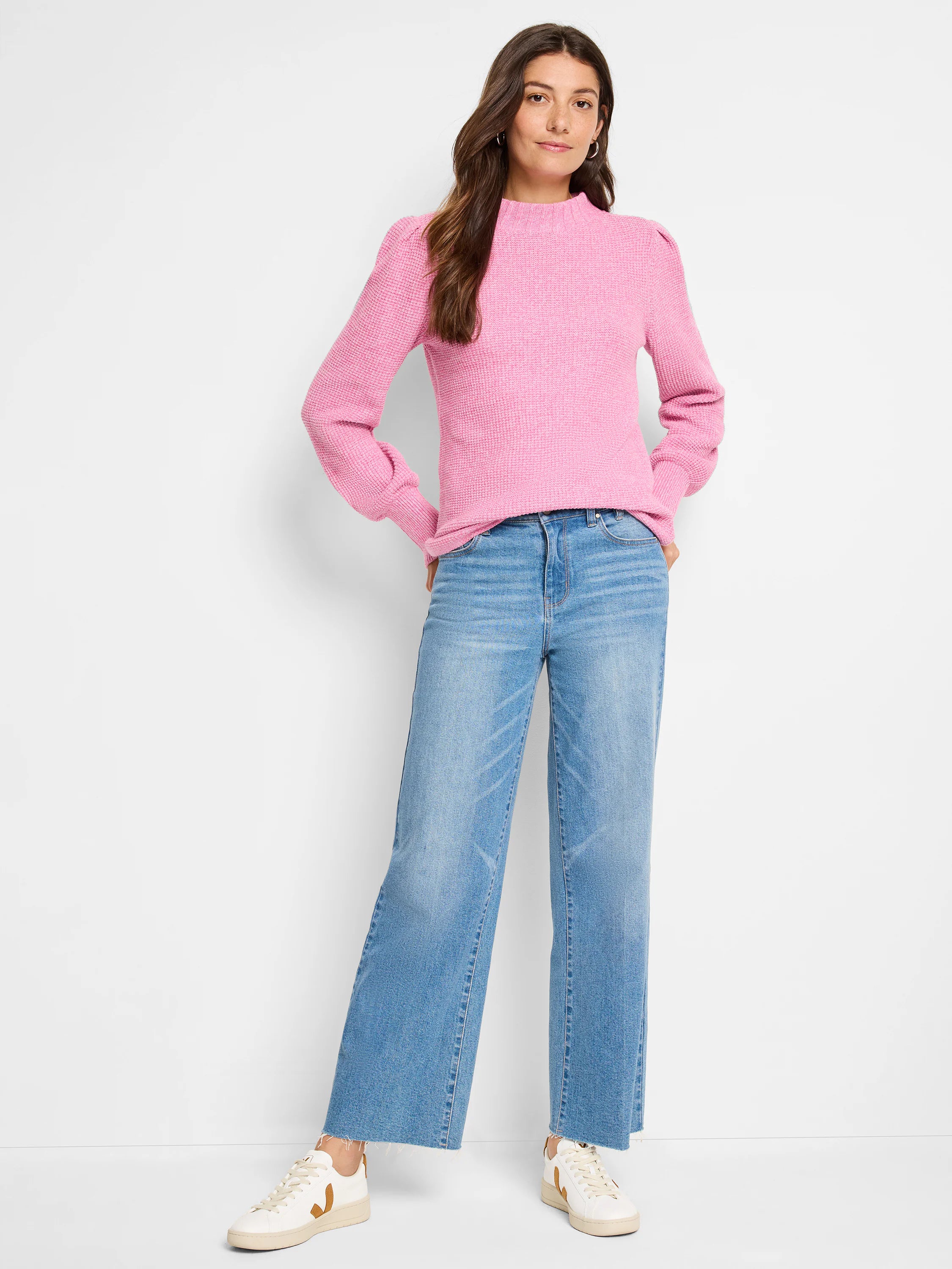 Pink waffle stitch sweater with mock neck, puffed shoulders, and ribbed cuffs.