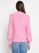 Pink waffle stitch sweater with a mock neck, puffed sleeves, and ribbed cuffs, shown from the back.