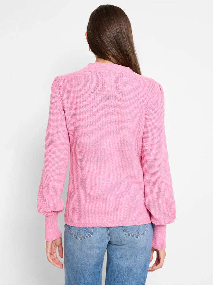 Pink waffle stitch sweater with a mock neck, puffed sleeves, and ribbed cuffs, shown from the back.