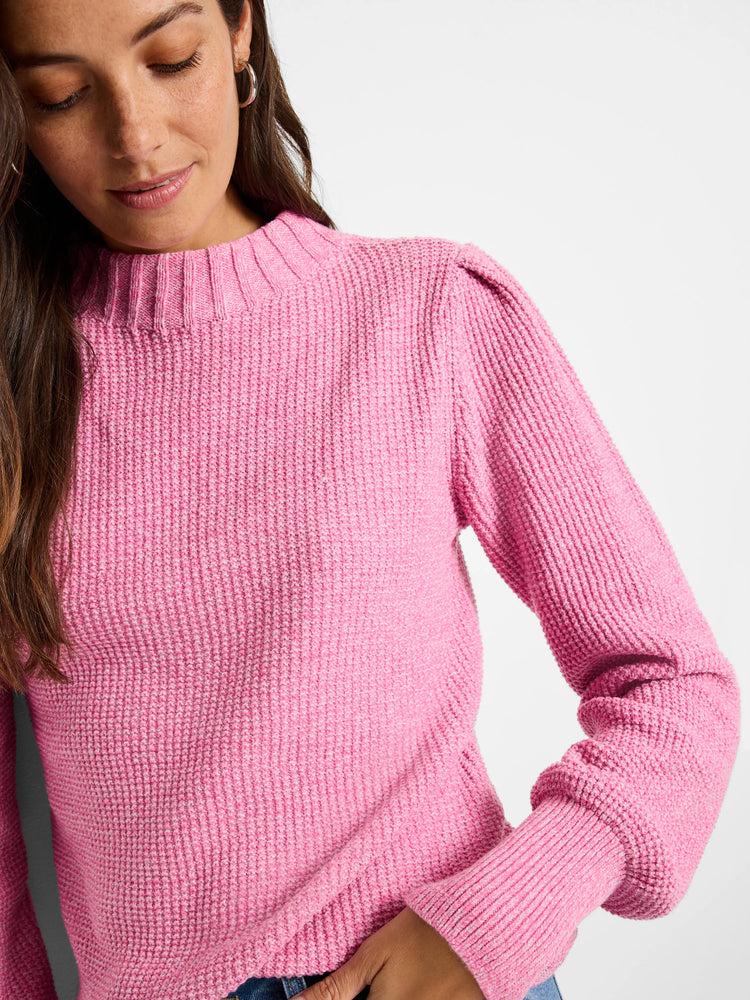 Pink waffle stitch sweater with ribbed mock neck, puffed shoulders, and ribbed cuffs.
