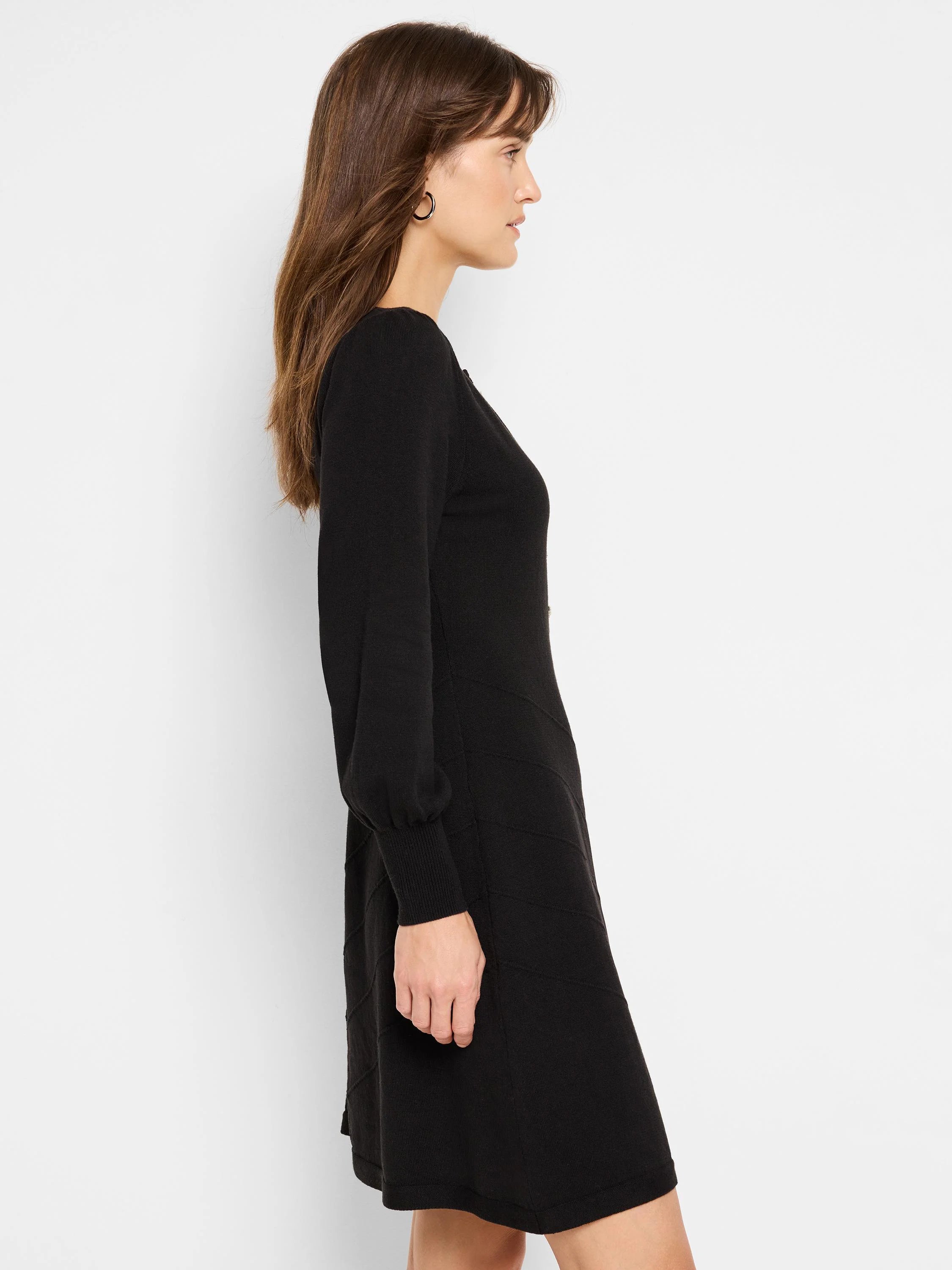 Black mini dress, long sleeves, fitted bodice, slightly flared skirt, subtle textured pattern.