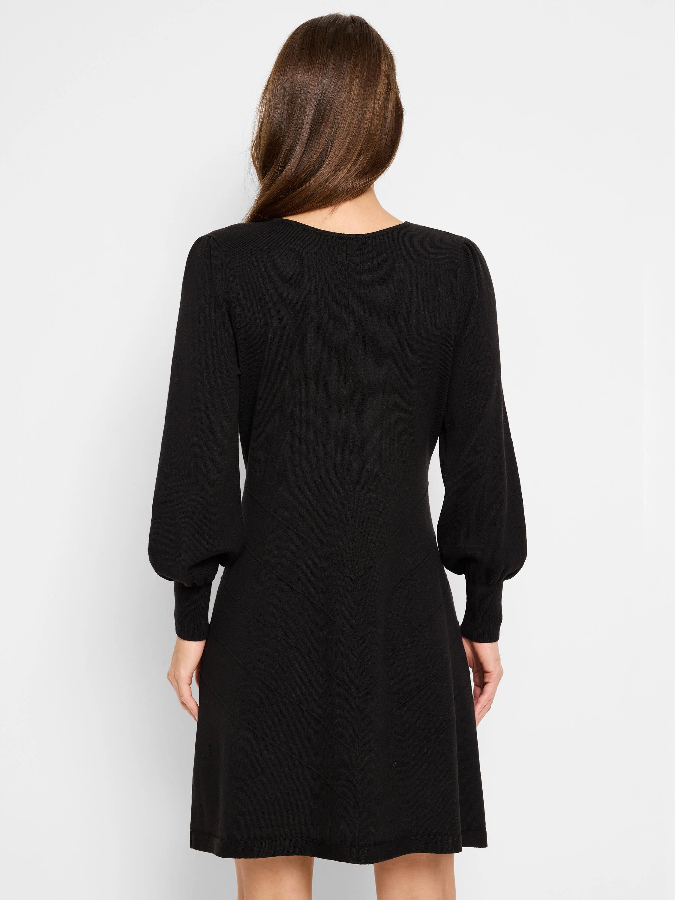 Black mini dress, long sleeves with puff shoulders,  V-neck, and chevron pattern detailing on the skirt.