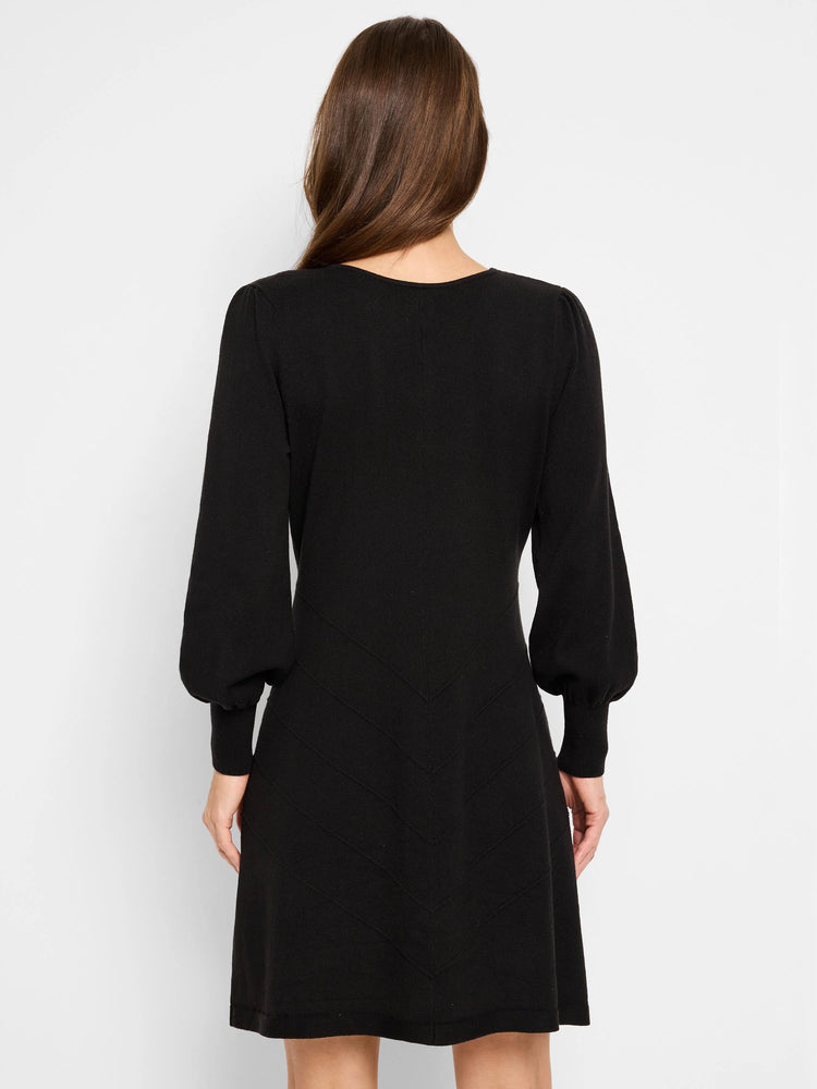 Black mini dress, long sleeves with puff shoulders,  V-neck, and chevron pattern detailing on the skirt.