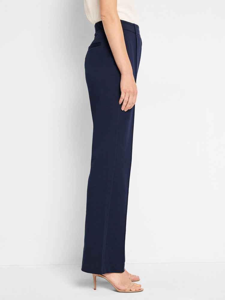 Navy blue wide-leg pleated pants; side view shows a straight, slightly flared leg.  The pants appear to have a high waist.