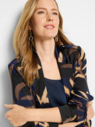 Midnight Fern trench jacket in navy, black, and beige abstract print.  Long sleeves, button cuffs.