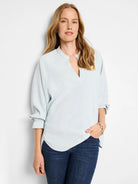 Light blue, V-neck, 3/4 sleeves with elasticized cuffs, relaxed fit.