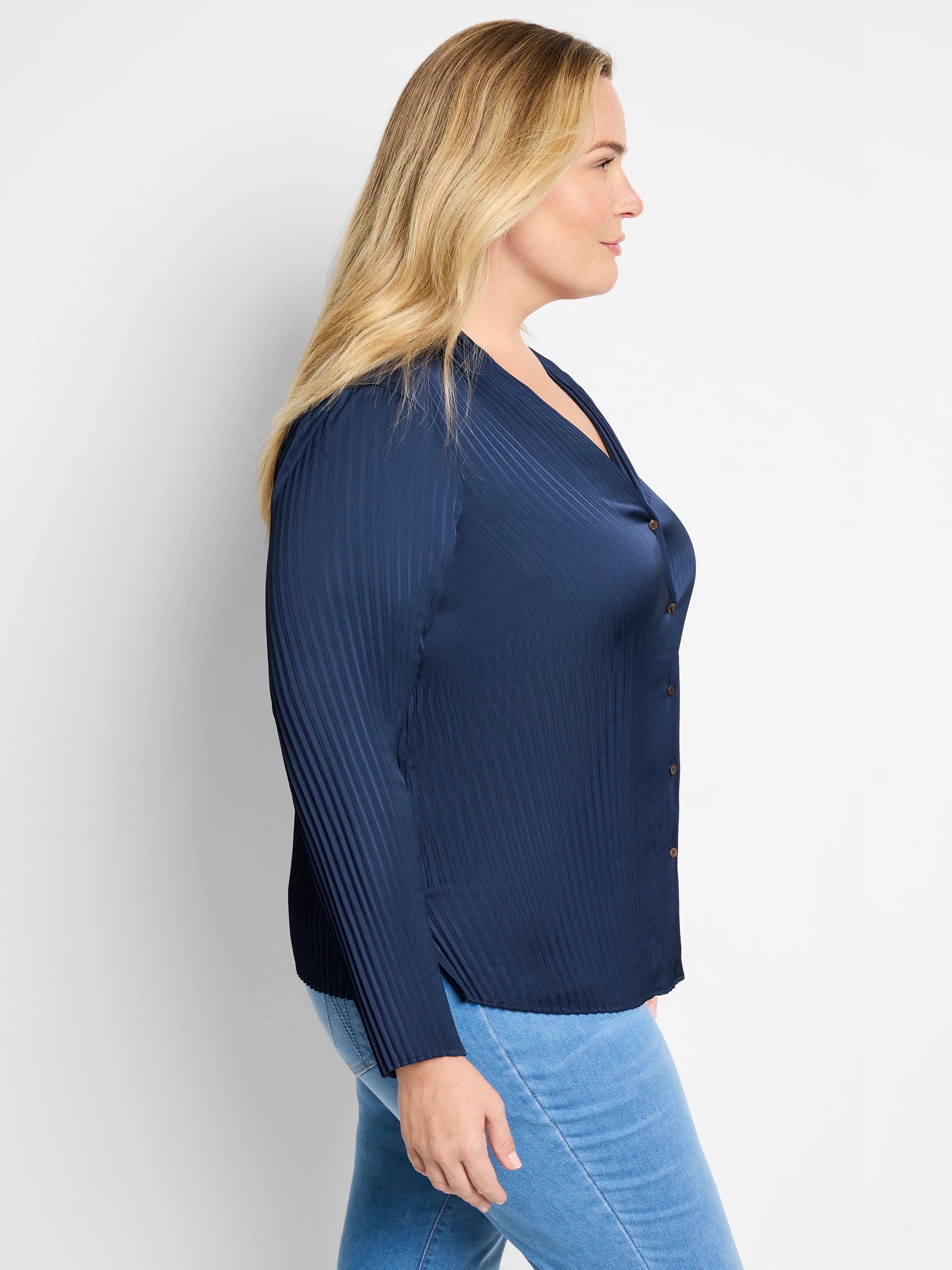 Navy blue, vertically pleated long-sleeve shirt with button front closure.
