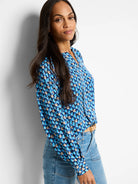 Blue, teal, and beige patterned long-sleeve blouse.  V-neck.