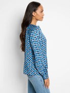 Blue, beige, and dark-blue patterned long-sleeve top.  Geometric print.