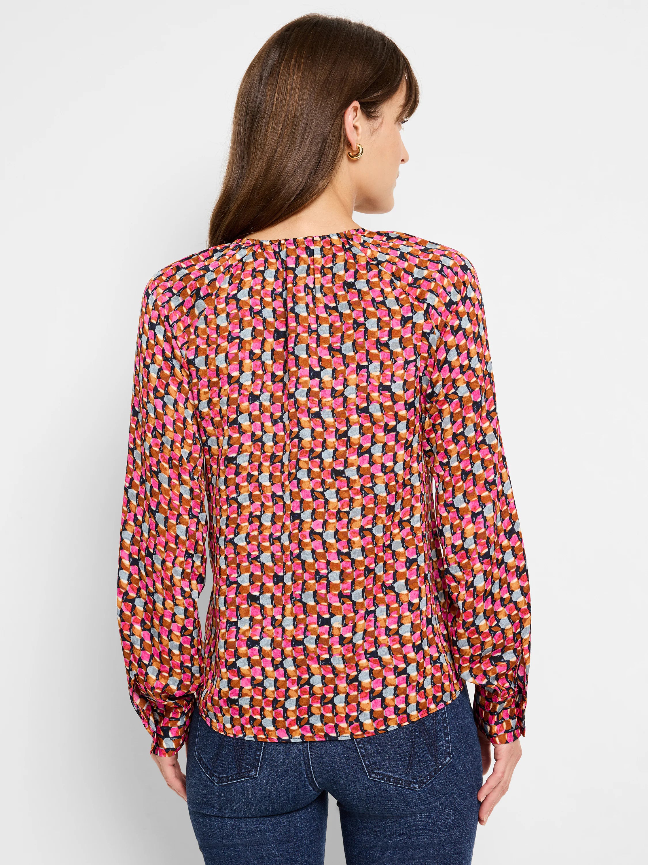 Long-sleeved top, pink, brown, and gray geometric pattern on a dark background.  Slight V-neck.
