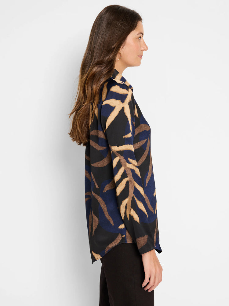 Long-sleeved shirt; navy, brown, and beige abstract leaf print on black background.  Collared.