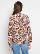 Brown, beige, pink, and blue abstract print long-sleeve blouse with a high neck.