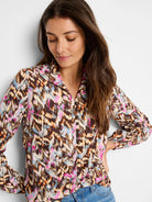 Brown long-sleeve button-up top with an abstract multicolor print including pinks, blues, and oranges.