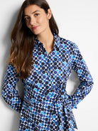 Long-sleeve collared shirt with side tie.  Blue, black, and white geometric print.