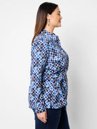 Side view of blue, black & white patterned shirt; long sleeves, side tie.