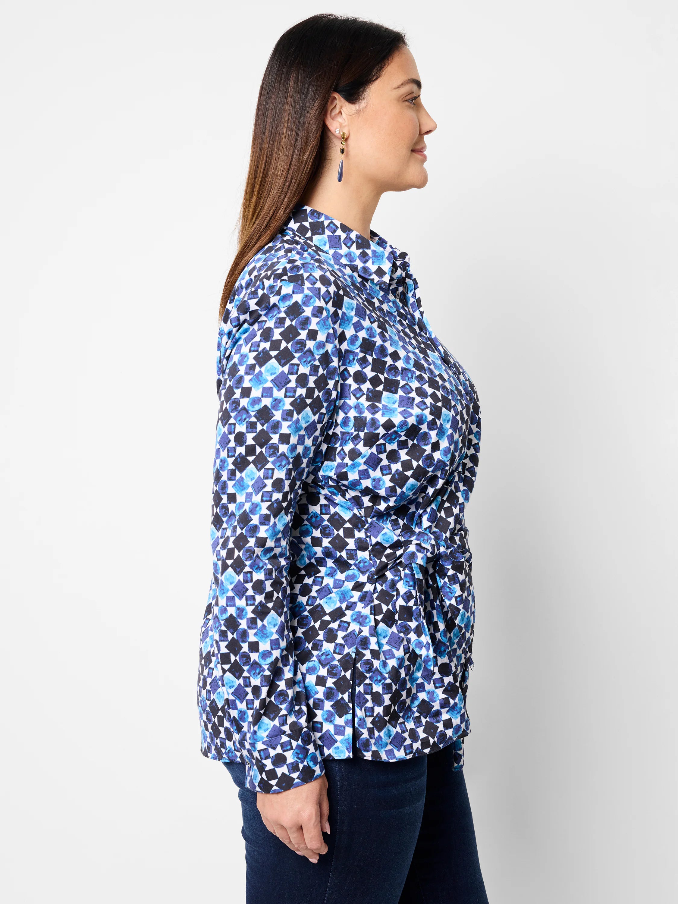 Side view of blue, black & white patterned shirt; long sleeves, side tie.
