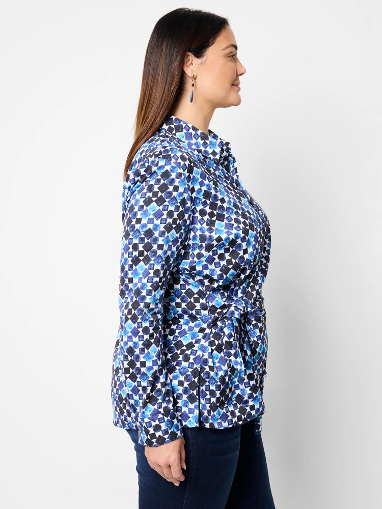 Side view of blue, black & white patterned shirt; long sleeves, side tie.