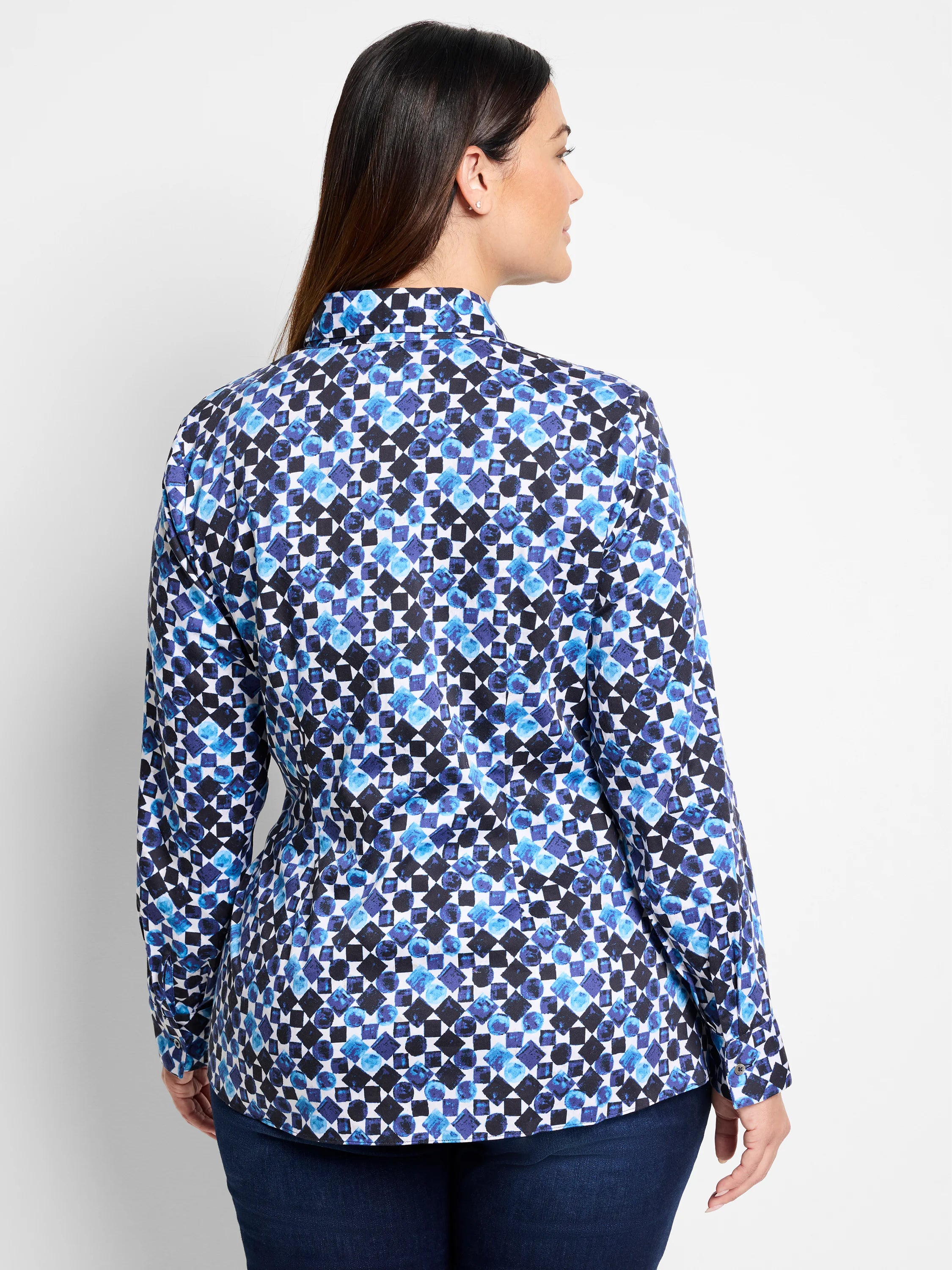 Back view of long-sleeve shirt. White background with blue and black abstract geometric pattern. Side tie detail.