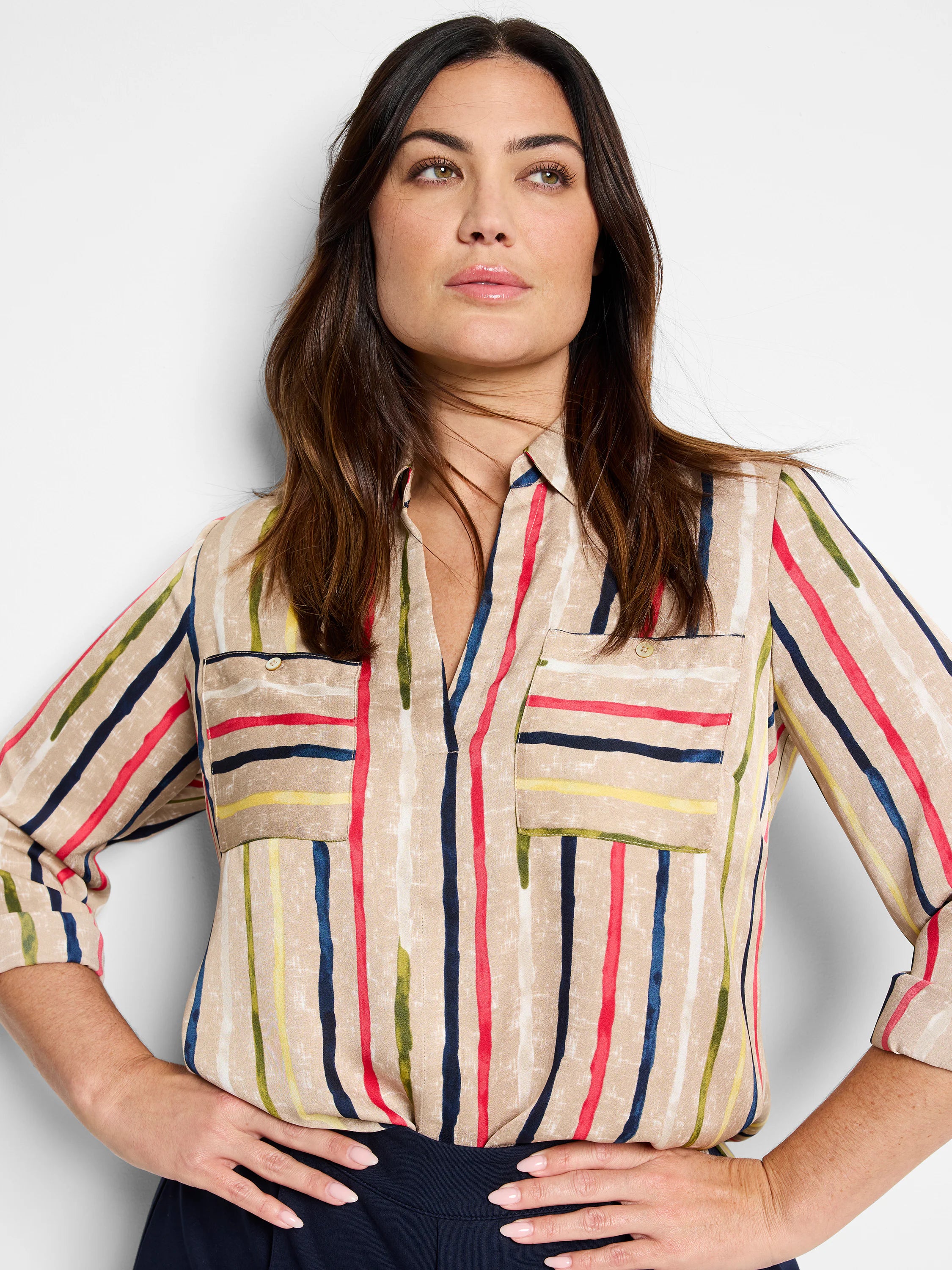 Tan top with irregular vertical stripes in red, navy, olive green, yellow, and white. Features a V-neck and two chest...