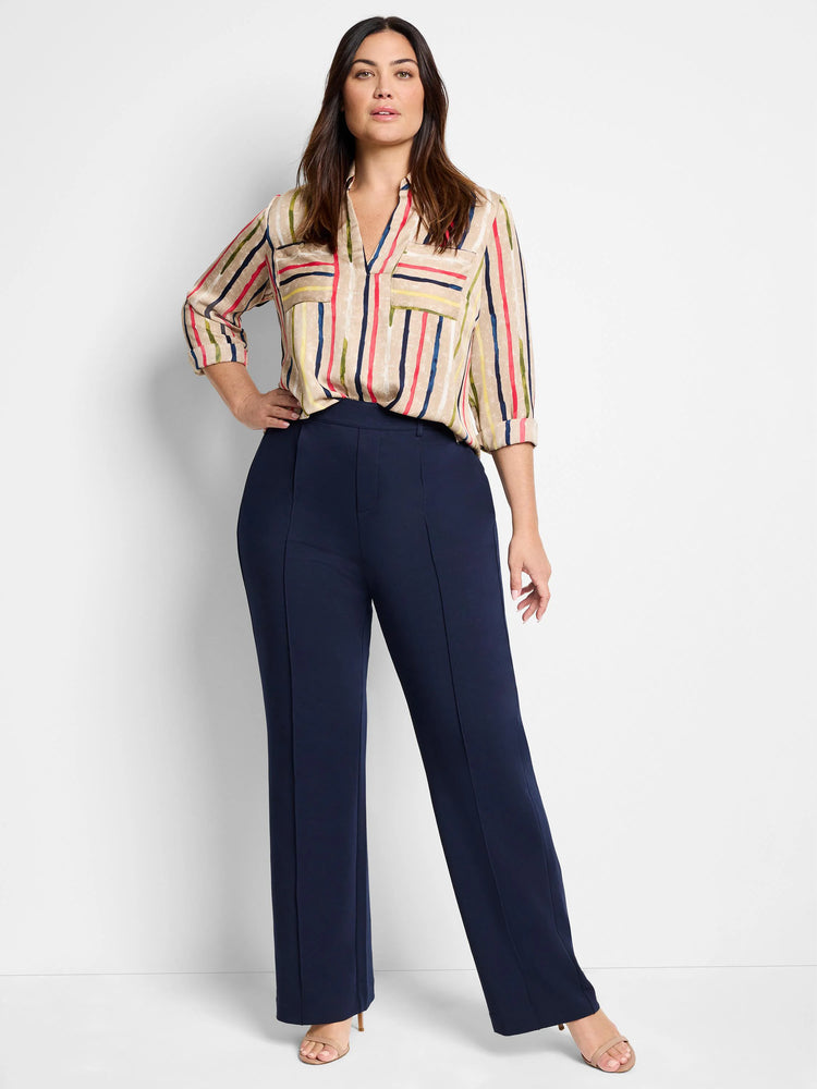 Beige blouse with painted vertical stripes in red, blue, green, and yellow. V-neck, chest pockets, 3/4 rolled sleeves.