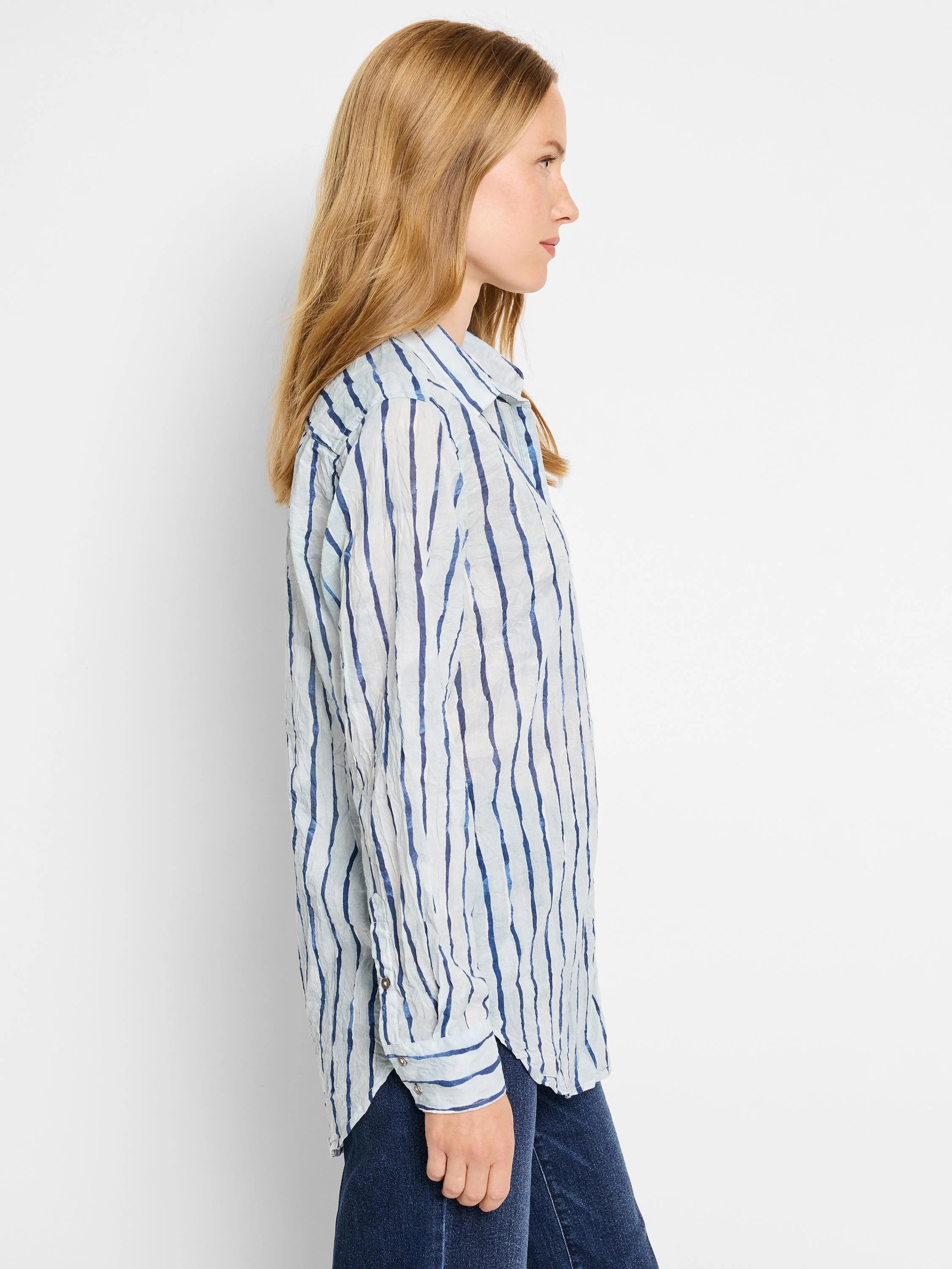 Watercolor-striped shirt; light blue background with darker blue vertical stripes.  Long sleeves, collared.