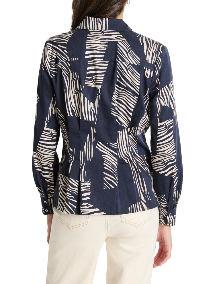 Here's alt text that meets the criteria:

"Dark navy blue shirt with off-white zebra stripes.  Long sleeves, collared.