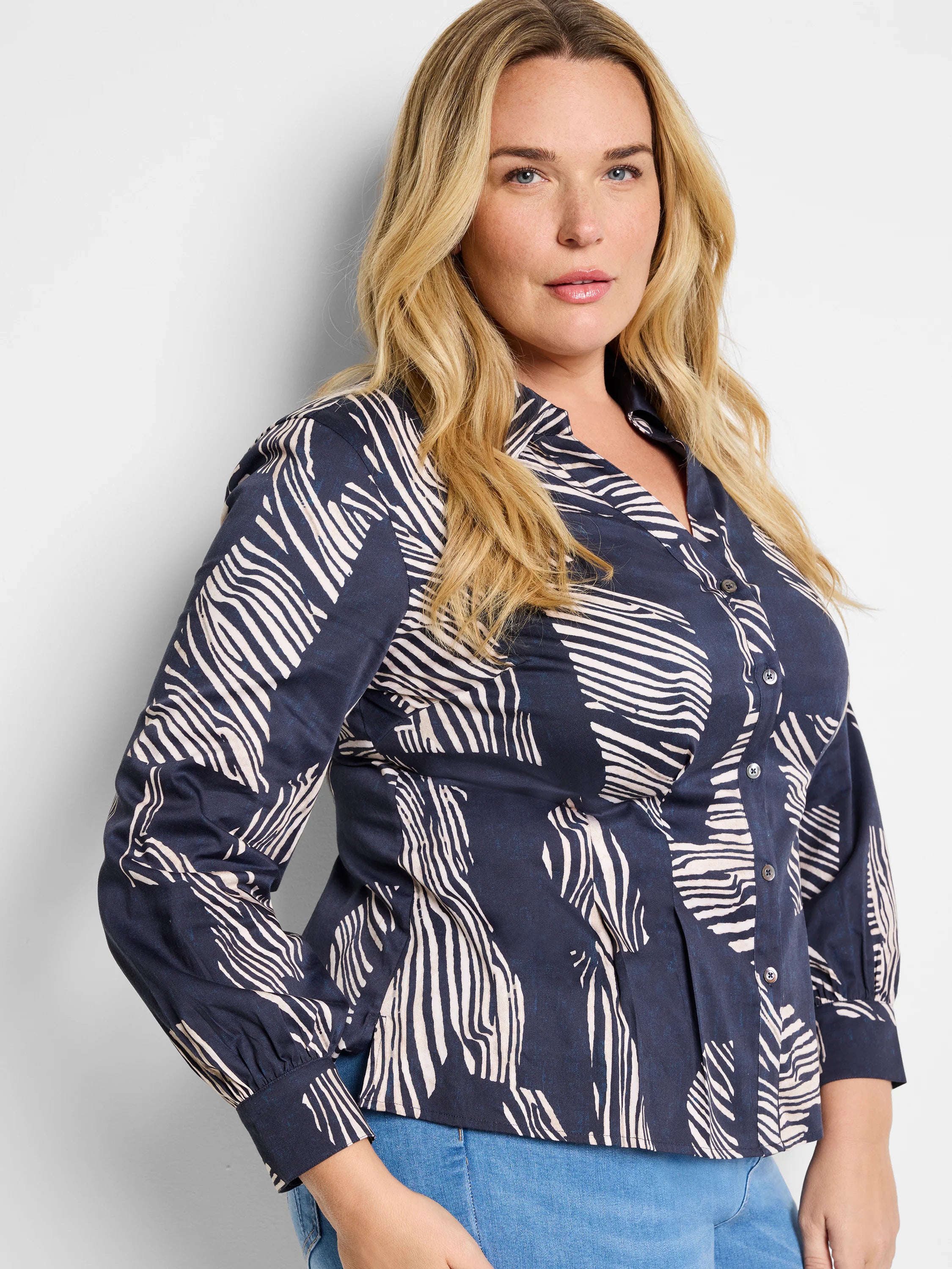 Navy blue shirt with an off-white zebra stripe pattern, long sleeves, and button closure.