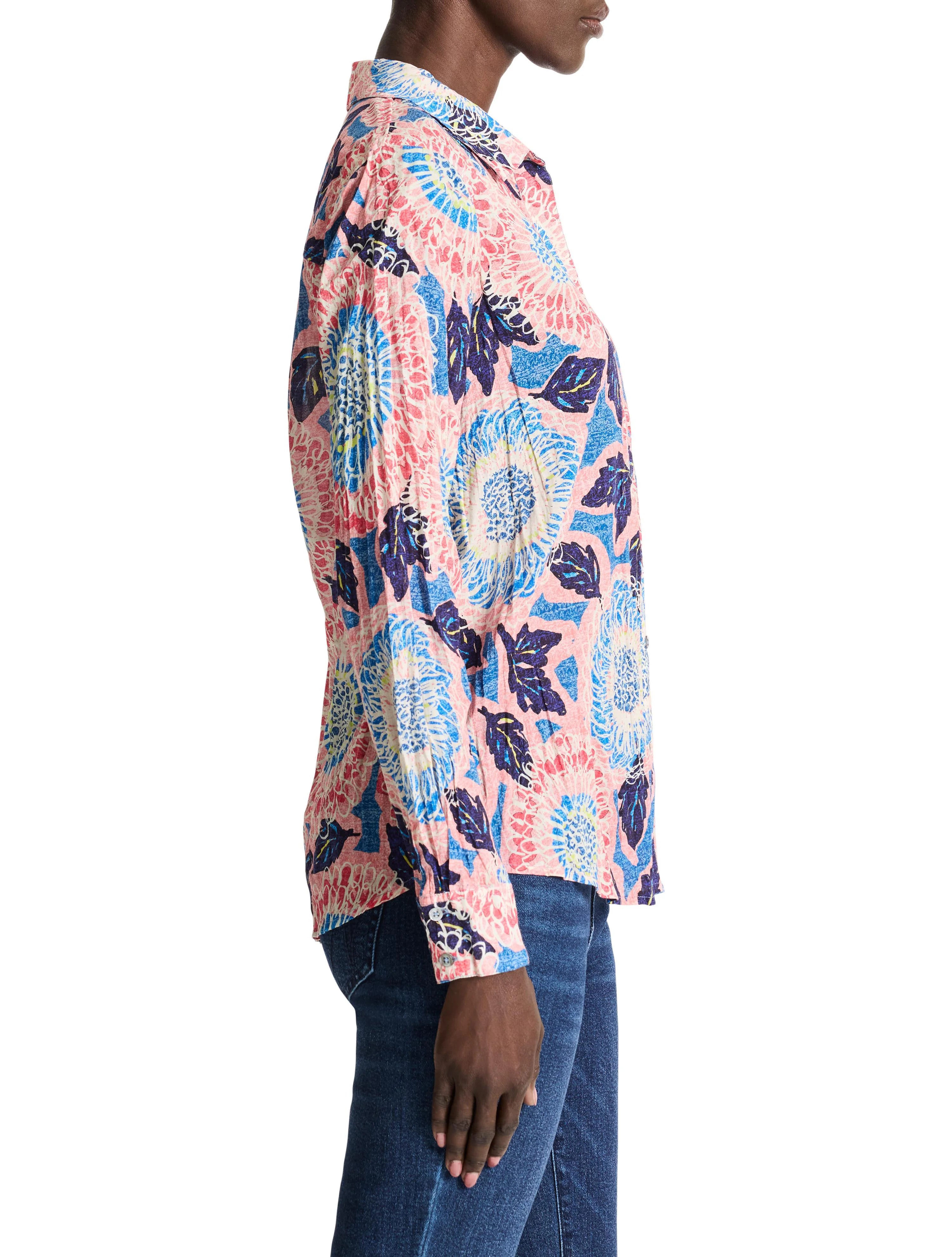 Pink long-sleeve shirt with blue, white, and dark-blue floral print.  Collared, button-front style.