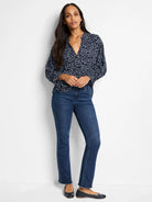 Navy top with light-blue small-scale pattern, worn with dark-wash jeans.